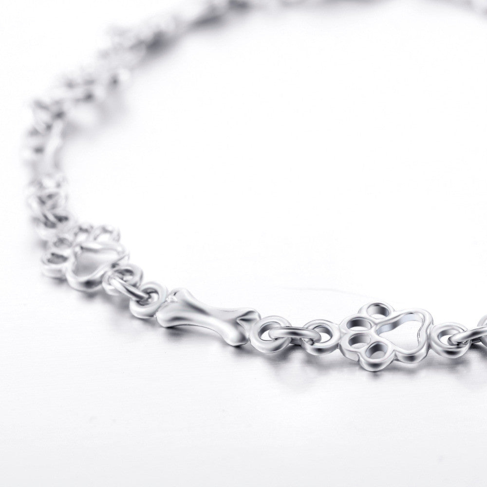 Silbernes Armband mit Hundepfoten- und Knochenanhänger