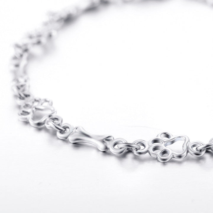 Silbernes Armband mit Hundepfoten- und Knochenanhänger